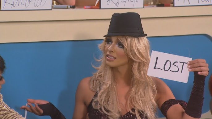 Tatianna as Britney Spears in The Snatch Game, holding a card that says, “Lost”